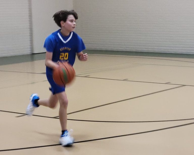 A Decatur Christian player dribbles the basketball up the court