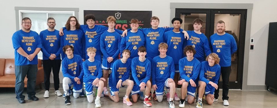 Decatur Christian high school boys basketball team and coaches in Warriors Never Fight Alone shirts