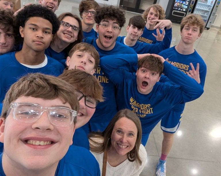 Decatur Christian basketball players smile together for a team selfie