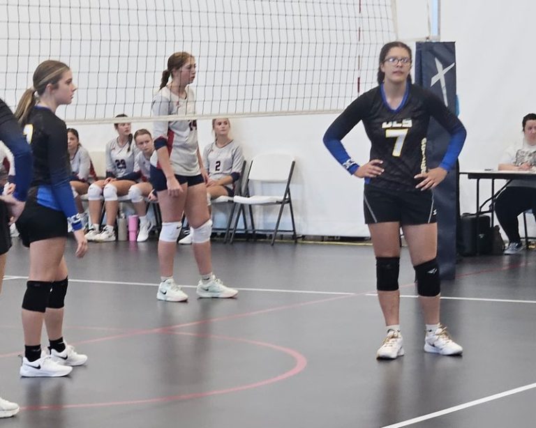 Decatur Christian volleyball players ready on the court during a match