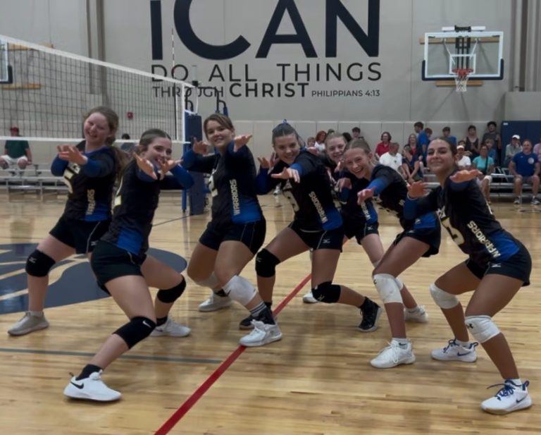 Decatur Christian Warriors volleyball team striking a fun pose on the court