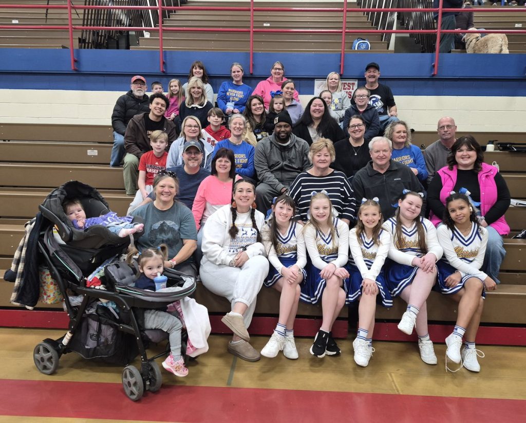 Decatur Christian families and cheerleaders gathered in the bleachers at a game